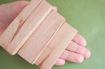 Hand holds a ladder made of wooden blocks. Career. Office staircase. Planning.