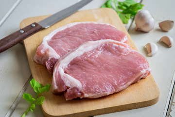 Raw pork meat on wooden board