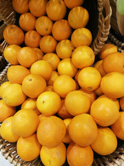 Orange fruits in a basket for sale.  Grocery.