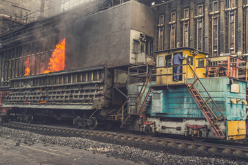 Issuing and transporting hot coke from coke oven closed batteries. For its further transportation and cooling. Before feeding coke to a blast furnace at a metallurgical plant.