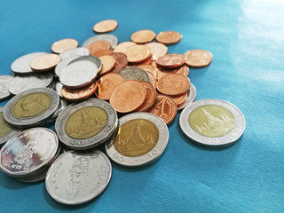 Thai baht coins on blue background