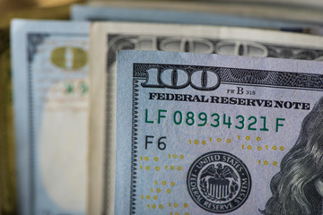A scattered bundle of hundred dollar bills.