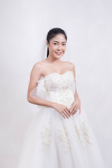 Asian woman is wearing wedding dress with free space on white background