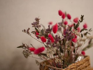 Beautiful dried flowers pink and purple flowers in a wicker basket