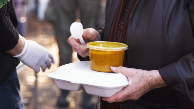 Warsaw, Poland 09.28.2019 - Volunteers help feed the homeless with vegetable soup. Close-Up.
