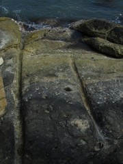 Vertical shot of cart ruts made on the stone