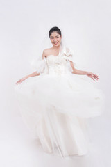Fototapeta premium Asian woman is wearing wedding dress with free space on white background