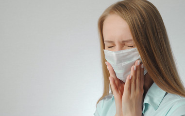 young blonde girl with toothache with medical mask