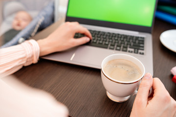 Fototapeta na wymiar Woman hands typing laptop computer with blank screen for mock up template background, business technology and lifestyle background concept. She is drinking coffee.