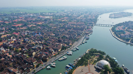 Fototapeta premium Aerial view of Hoi An old town on Thu Bon river, Quang Nam province, Vietnam. Unesco world heritage. River bifurcation.