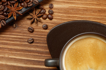 Coffee cup and coffee beans on a wooden background. Top view .