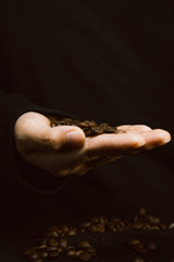 Coffee beans on hand on showing gestures