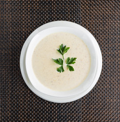 mushroom cream soup with cream in a white bowl