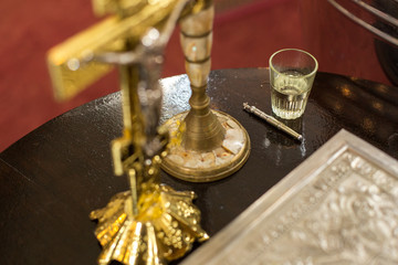 golden cross and holy bible on table