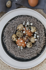 Fragment of easter table setting with chicken and quail eggs