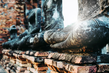 Fototapeta na wymiar Blurred Background antique buddha pagoda statue in Thailand Ayutthaya buddhist ancient temple. Thai tourist pray for good luck, zen peaceful and holy meditation relax.