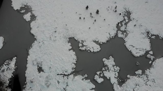 Frozen Mountain Lake and Forest At Winter Season -aerial view
