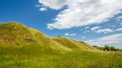 grass-covered hills above the valley on a sunny day
