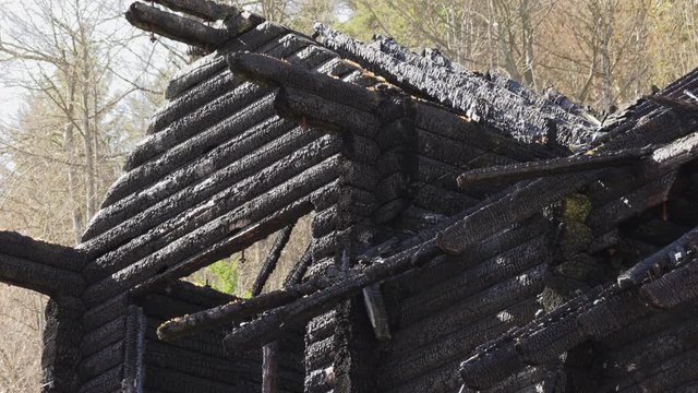 burnt wooden log house, charred wood
