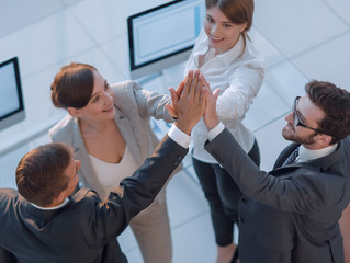 successful business team giving each other a high-five, standing