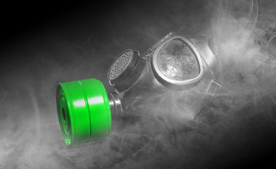 Vintage gasmask isolated on black - Smoke in the room - Green filter