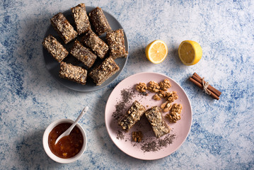 Homemade poppy seeds pie with with ingredients for baking on a rustic table, breakfast or dessert, traditional poppy pie with chopped walnuts and apricot jam - Top View