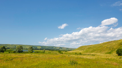 Fototapeta na wymiar valley, meadow between hills with dirt country road