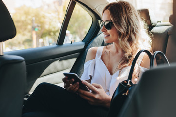 Female real estate agent traveling by a car