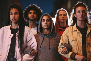 Activists marching together holding hands