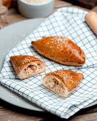 pies of chicken sprinkled with sesame seeds © Kamran