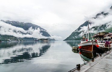 Idyllic view on cloudy fjord Sorfjorden, harbor port marina in Odda, Norway.
