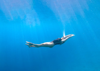 Fototapeta na wymiar Free Diver girl floating under the water in the Red Sea