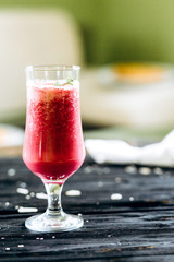 A row of healthy fresh fruit smoothies with mint on dark backgrounds