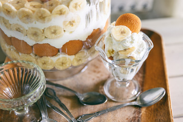Banana pudding, popular in the Southern United States, made with vanilla wafer cookies, pudding, whipped cream, and banana slices. Shown in a trifle bowl. 