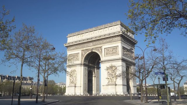 Paris street with the Arc de Triomphe in Paris, France.
