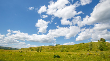 grass-covered hills above the valley on a sunny day