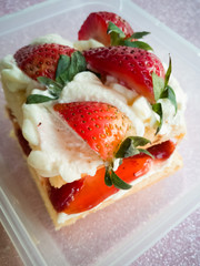 Victoria sponge cake in a container.