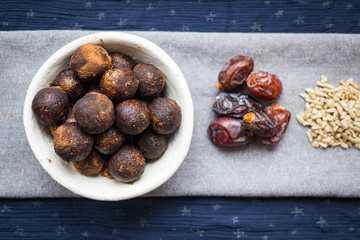 Black truffle chocolate energy protein sweet balls. Vegan cocoa dieting raw dessert. Ingredients - date fruits, sesame seeds, sunflower seeds. 