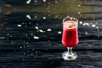 A row of healthy fresh fruit smoothies with mint on dark backgrounds