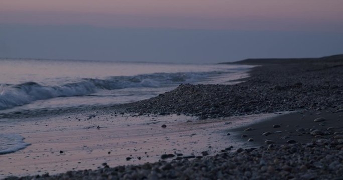 Focused shoreline waves crashing rocky beach, sunrise, Mojacar, Almeria, Spain