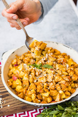 Cinnamon apples baked in pan. Sweet vegan dessert. Woman hands.