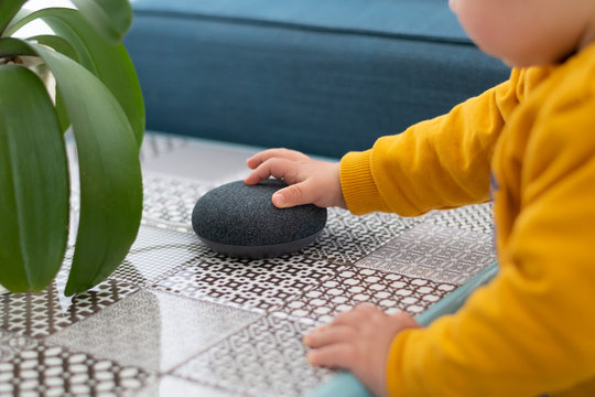 Child Interacting With Smart Home Assistant Speaker