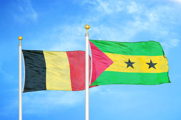 Belgium and Sao Tome and Principe two flags on flagpoles and blue cloudy sky