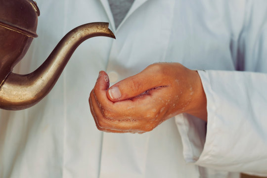 Arabic Doctor Woman  Washing Hands  With Soap And Using Copper Jug Water For Corona Virus Prevention, Hygiene To Stop Spreading Coronavirus.