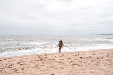 Asian young adult alone woman standing relax at the beach.
