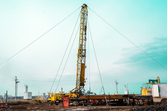 Drilling An Oil Well And Conducting Geophysical Surveys To Increase Oil Production. An Oil Well Engineer Works From The Back Of Specialised Van To Log The Condition Of Steel Casing Inside An Oil Well.