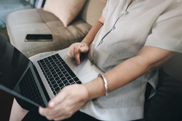 Elder hand woman use laptop for online education lesson.