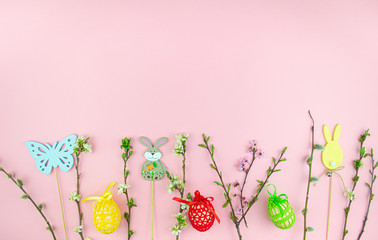 Easter decorations on ping background - eggs, flowers and the easter bunny