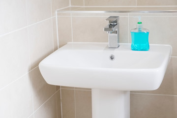 Anti bacterial blue hand wash on hand basin to prevent coronavirus and other germs or virus