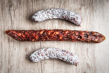 delicious sausages on wooden background